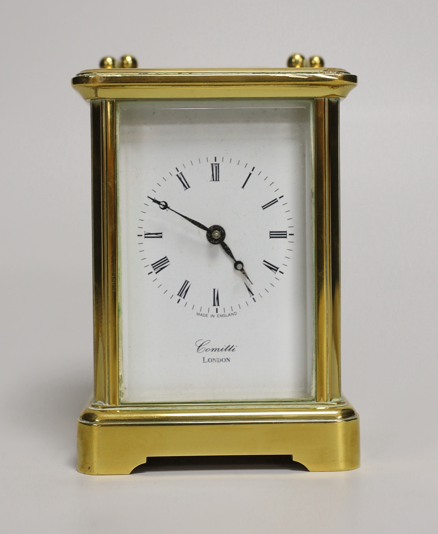 A brass eight day carriage timepiece, retailed by Comitti of London, 12cm high